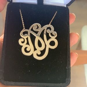 Monogram M gold necklace.